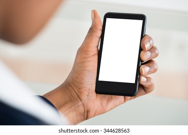 Close-up Of Woman's Hand Holding Mobile Phone With Blank Screen