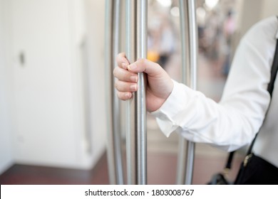 Close-up Of A Woman's Hand Holding A Pole On The Subway.