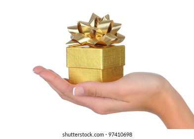 Closeup Of A Woman's Hand Holding A Small Gold Gift Box. Horizontal Format Over White.