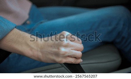 Close-up of a woman's hand operating the gearshift lever while driving