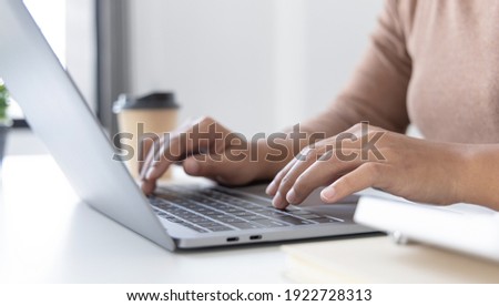 Close-up of a woman's hand pressing on the laptop keyboard, World of technology and internet communication, Financial professionals use laptop to calculate and check real estate earnings.