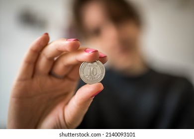 Closeup Of Woman's Hand Showing Silver Coin Of 10 Ukrainian Hryvnias. Inflation Economy Concept