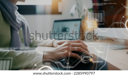 Close-up of a woman's hand using a computer mouse while interacting with a futuristic UI interface displaying data provided by artificial intelligence in augmented reality