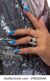 closeup the woman's hand wearing luxury ring  blue gradient nail art manicure silver sequin material background 