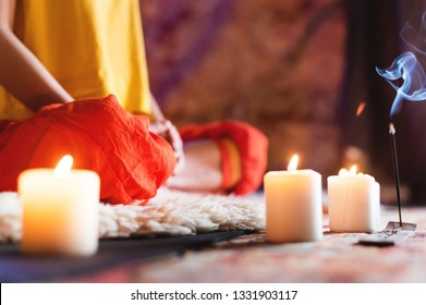 Close-up Of Woman's Hand In Yoga Lotus Pose Meditating In A Crafting Room With Candles