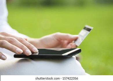 Close-up Woman's Hands Holding A Credit Card And Using Cell Phone, Online Shopping, Outdoor