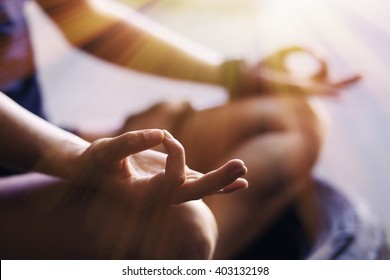 Closeup of woman's hands meditating indoors