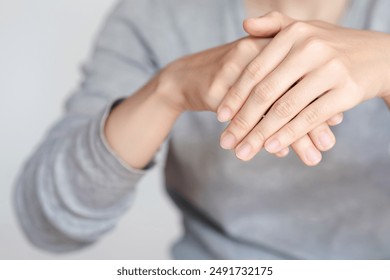 Close-up of woman's hands and nails with a focus on their healthy appearance, emphasizing the concept of health care.