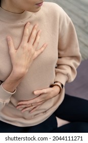 Close-up of a woman's hands on her chest while doing breathing exercises. Caucasian woman sitting in a lotus position, practicing pranayama - Shutterstock ID 2044111271