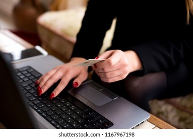 Closeup woman's hands typing on a laptop