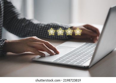 Closeup Woman's Hands Using Laptop With 4 Stars Above, Satisfaction Survey Concept