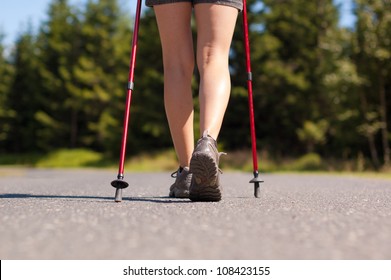 Closeup Of Woman's Legs With Nordic Walking Poles