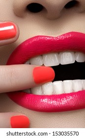 Close-up Of Woman's Lips With Fashion Hot Pink Lipstick Makeup. Beauty Macro Sexy Make-up With Bright Magenta Color On Nails.