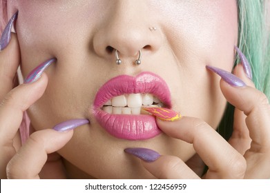 Close-up of woman's mouth and fingers