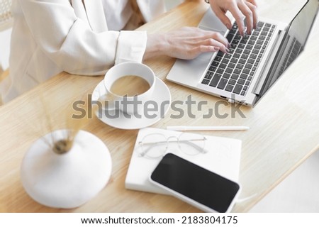 Close-up of a woman's right hand typing on a laptop. Workplace of unrecognizable business lady. Distant work.