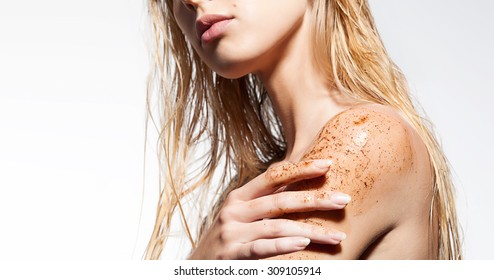 Close-up of a woman's shoulder with scrub of coffee