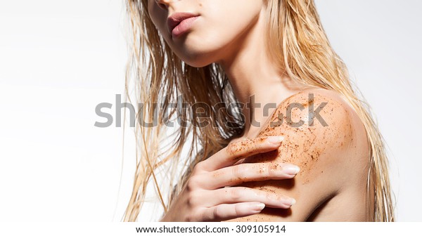 Close-up of a\
woman\'s shoulder with scrub of\
coffee