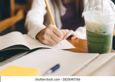 Closeup Women Hand Writing Note For Math Study And Work Online At Cafe. University People Activity Campus Lifestyle On Day Time Concept.