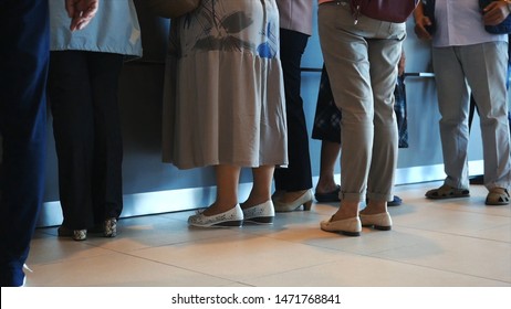 Close-up of women and man waiting in queue in the hospital or post. Media. People waiting quietly for their turn