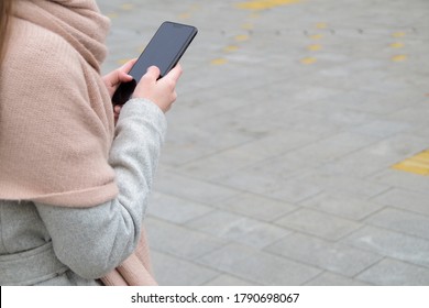 Close-up Women On The Street Holding Phone. Negative Space. Copy Space For Text.