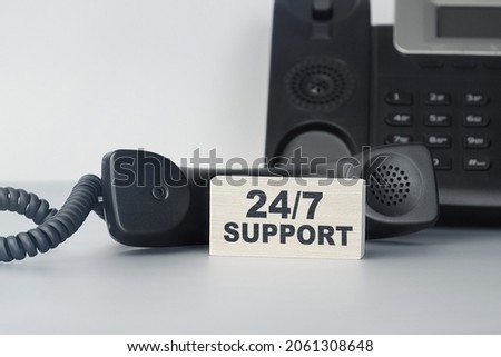 Closeup of the wooden block with text - 24-7 support - Always available support. Office and communication concept
