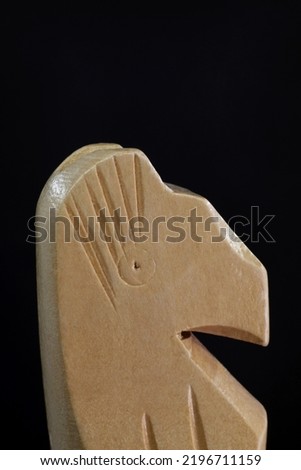 close-up wooden chess piece knight on black background
