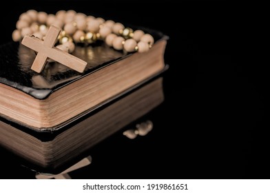 Closeup Of Wooden Christian Cross On Bible And Prayer Beads, Chu