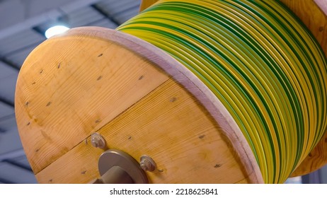 Close-up wooden coil of electric cable indoor. High and low voltage cables in the storage. - Shutterstock ID 2218625841