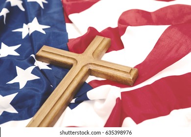 Closeup of wooden crucifix over an American flag, memorial day concept