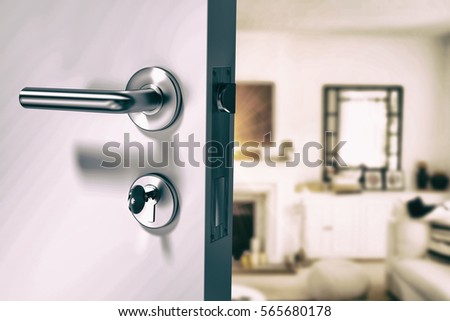 Closeup of wooden door with metallic doorknob against view of living room