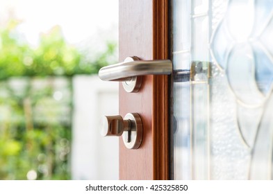 Close-up wooden door opening with blur garden background - Powered by Shutterstock