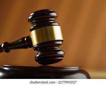 Close-up. Wooden judge's gavel on a beige background. Court, justice, presumption of innocence, Constitution, rule of law, auction. Banner, poster. There is no one in the photo.