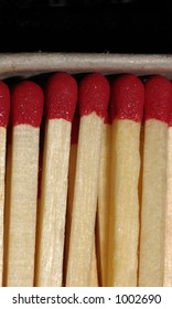 A close-up of wooden matches in a box with room at the top of the image for text.