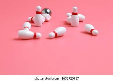 Closeup Of A Wooden Mini Bowling Game Set And Pins On Pink Background