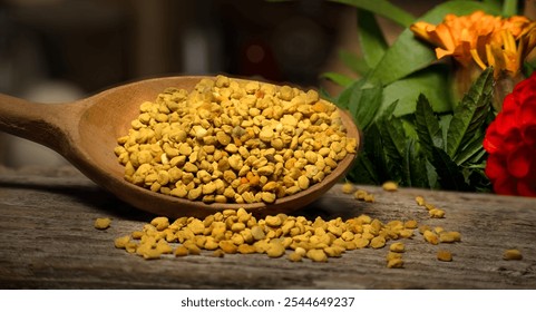 Close-up of a wooden spoon brimming with golden bee pollen, resting on a rustic wooden surface, against a colorful garden background, symbolizing natural health and vitality - Powered by Shutterstock