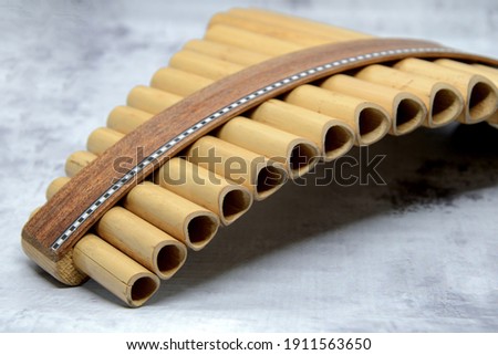 Close-up of woodwind instrument pan flute. Details of musical instruments, music. Selective focus, blurred background.