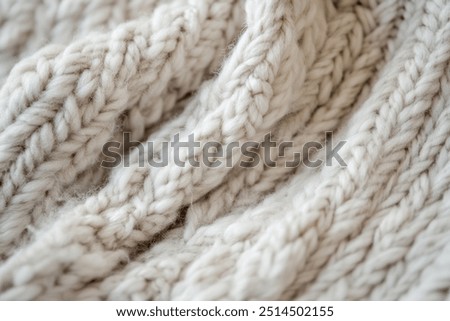 Close-up of Wool Sweater Knit Pattern. An up-close image of a wool sweater that captures the delicate knit design and the cozy, plush texture of the wool, showcasing its softness.