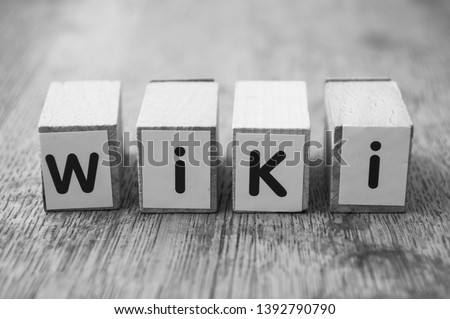Closeup of word on wooden cube on wooden desk background concept - Wiki