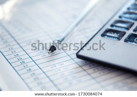 Close-up of work entry record, pen and calculator. Human resources concept.
