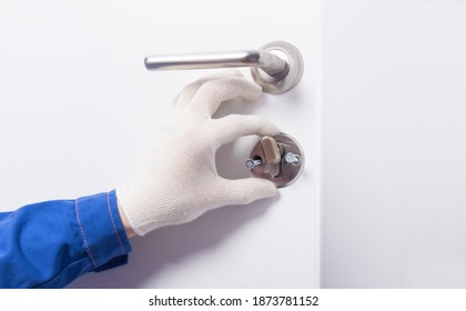 close-up, work of a locksmith in the process of repairing the door lock, view from inside the room