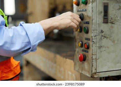 closeup worker hands working at machine control panel and push a button in the factory