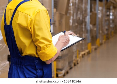 Closeup of a worker with list checking stock condition
