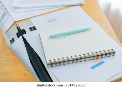 Closeup worker planning with pen, notes and schedule of information in journal, reports or logistics agenda, strategy and online data analysis at desk. Worker, computer and notebook