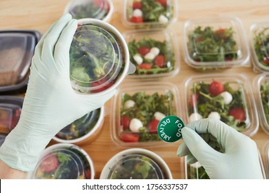 Close-up Of Worker In Protective Gloves Preparing Food For Delivery