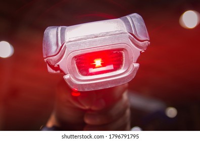 Close-up Worker Scanning Barcode Scanner With Red Laser.