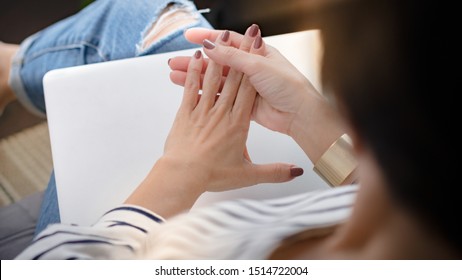 Closeup of a working woman's hands, she straighten her fingers that gets stiffness in the morning from trigger finger disease (locking finger or stenosing tenosynovitis). Numbness, Office syndrome