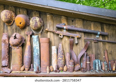 Close-up of World War II artifacts recovered from the Courland Pocket battlefield. Rusted relics displayed as a reminder of wartime history
