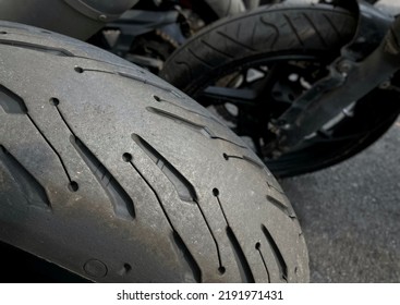 Closeup of worn motorcycle tire at a motorbike service center.