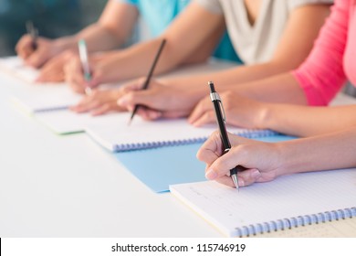 Close-up of writing hands of students at school - Powered by Shutterstock