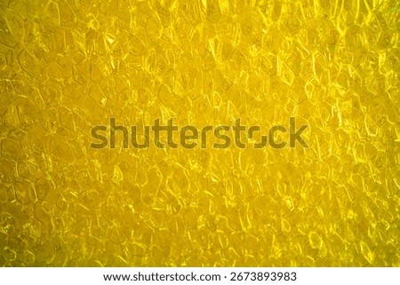 Close-up of a yellow bubble foam texture.